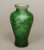 ANDRE DELATTE (1887-1953) French A green etched cameo glass vase Decorated with trees in a