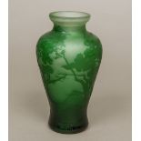 ANDRE DELATTE (1887-1953) French A green etched cameo glass vase Decorated with trees in a