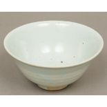 An antique Chinese celadon bowl Of deep flared form, with light coloured glaze. 17.5 cm diameter.