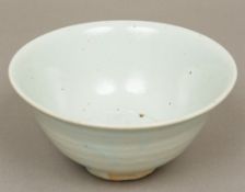 An antique Chinese celadon bowl Of deep flared form, with light coloured glaze. 17.5 cm diameter.