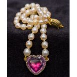 A pearl necklace Set with a 9 ct gold clasp and a diamond and paste set heart shaped pendant.