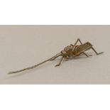 A Japanese patinated bronze articulated model of a locust Typically modelled. 15 cm long.