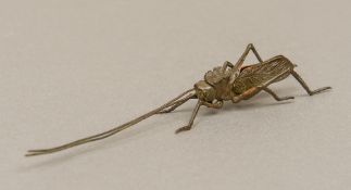 A Japanese patinated bronze articulated model of a locust Typically modelled. 15 cm long.