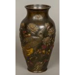 A Japanese Meiji period gilt heightened bronze vase Decorated with a peacock amongst blossoming