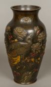 A Japanese Meiji period gilt heightened bronze vase Decorated with a peacock amongst blossoming