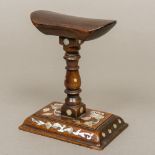 A 19th century Chinese mother-of-pearl inlaid carved hardwood headrest The gently dished top above