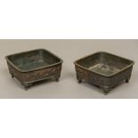 A pair of 19th century Chinese bronze censers Each of square section and worked with dragons