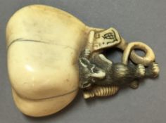 An 18th/19th century Japanese carved ivory netsuke Worked as a rat carrying a yoke and issuing an