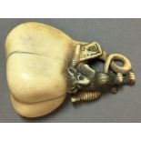 An 18th/19th century Japanese carved ivory netsuke Worked as a rat carrying a yoke and issuing an