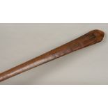A 19th century Polynesian carved wooden paddle club Of typical flattened spreading form with raised