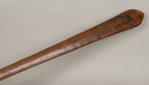 A 19th century Polynesian carved wooden paddle club Of typical flattened spreading form with raised