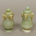 A pair of Chinese carved jade lidded vases Each with circular lid and carved with four mythical