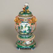 A 19th century Japanese porcelain lidded censer on stand The pierced removable lid surmounted with