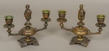 A pair of 19th century patinated bronze twin branch candelabra Each centred with an African child