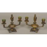 A pair of 19th century patinated bronze twin branch candelabra Each centred with an African child