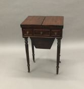 A 19th century mahogany work table The hinged folding top enclosing the lidded workbox,