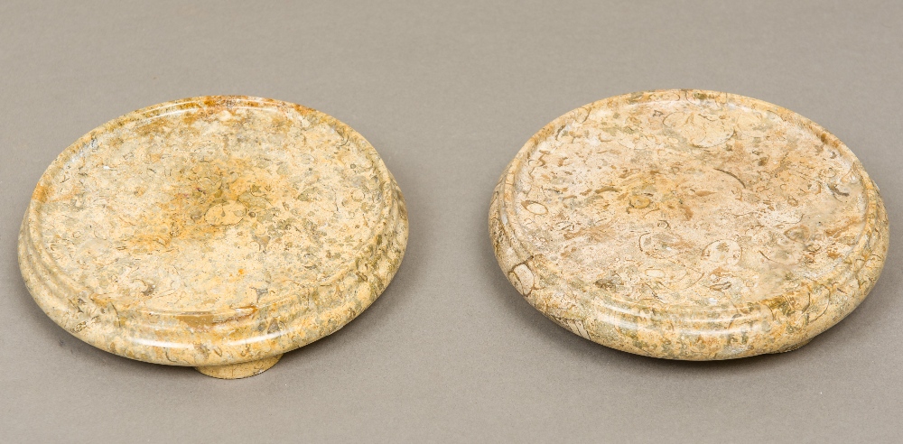 A pair of carved fossilized stone urn stands Of circular section with demi-lune block feet.