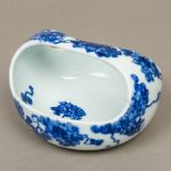 A Japanese blue and white porcelain basket Of simple dished form with a shaped loop handle,