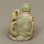 A Chinese carved green and russet jade snuff bottle Decorated with flowering branches. 7.