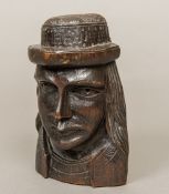 A 19th century Continental carved wood mask The long haired figure wearing a hat, flat backed.