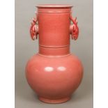 A large red ground Chinese pottery vase The elongated neck with twin deer mask handles,