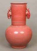 A large red ground Chinese pottery vase The elongated neck with twin deer mask handles,