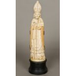 A large early 19th century Dieppe carved ivory triptych Formed as a bishop enclosing a scene of