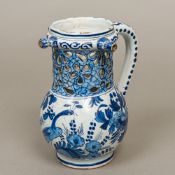 A Dutch Delft blue and white pottery puzzle jug With pierced neck and decorated with peacocks,