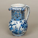 A Dutch Delft blue and white pottery puzzle jug With pierced neck and decorated with peacocks,