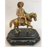 A 19th century gilt bronze group Modelled as a young man riding an horse side saddle,