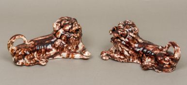 A pair of Whieldon type 19th century Staffordshire agate ware pottery lions Each modelled recumbent