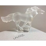 A Lalique frosted and clear glass Kazak horse Typically modelled, signed, boxed. 18 cm long.