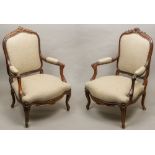 A pair of 19th century French upholstered rosewood open armchairs Each with scroll and floral