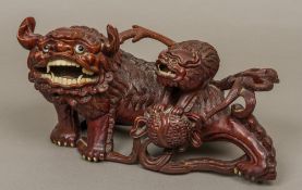 A Chinese carved wooden group Formed as a large dog-of-fo with a smaller dog-of-fo on its back.
