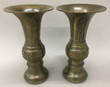 A pair of 19th century Chinese bronze vases Both with lappet cast flared rims and decorated with