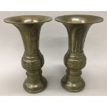 A pair of 19th century Chinese bronze vases Both with lappet cast flared rims and decorated with