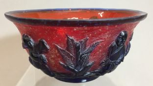 A Chinese 19th/20th century Beijing glass bowl Carved with four boys in blue on a red ground worked