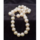 A pearl bead necklace Set with 18 ct white gold clasp and diamond set spacers. 44.5 cm long.