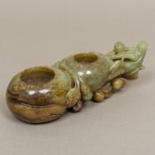 A Chinese carved jade brush pot Of double gourd form, carved with a figure. 19 cm long.