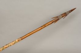 A Fijian tribal spear Of multi-spiked form with woven hand grip. 178 cm long.