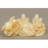 A Chinese carved mutton fat jade brush rest Of figural form. 16.5 cm long.