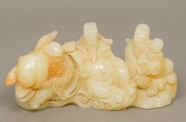 A Chinese carved mutton fat jade brush rest Of figural form. 16.5 cm long.