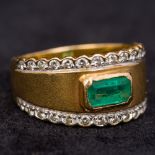 A high carat gold, diamond and emerald ring Of band form,
