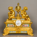 A 19th century French painted porcelain mounted ormolu mantel clock The white enamelled dial with