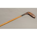 A Victorian Sunday stick Of typical golf club form, the shaft stamped E RAYNER. 90 cm high.