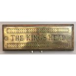 A Victorian brass mounted Taverns cribbage board inscribed The King's Head 41.5 cm wide.