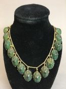 A gilt metal mounted green scarab beetle fringe necklace Comprising twenty-nine beetles.