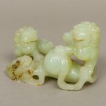 A Chinese carved jade group Formed as three dogs-of-fo. 15 cm long.