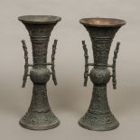 A pair of Chinese archaistic style patinated bronze vases Each of flared cylindrical form with twin