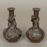 A pair of Japanese Meiji bronze vases Each worked with a dragon and birds amongst floral sprays.